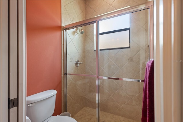 bathroom featuring toilet and walk in shower