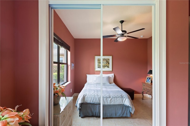 bedroom featuring light tile patterned floors and ceiling fan