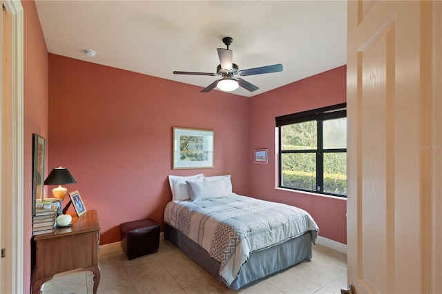 bedroom featuring light tile patterned floors and ceiling fan