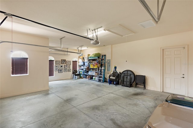 garage with electric panel and a garage door opener