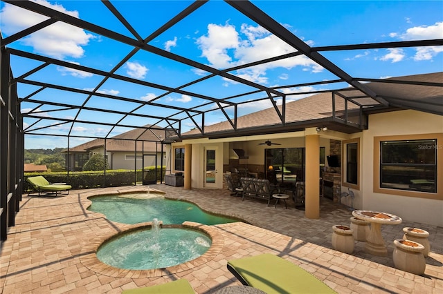 view of swimming pool featuring glass enclosure, an in ground hot tub, and a patio