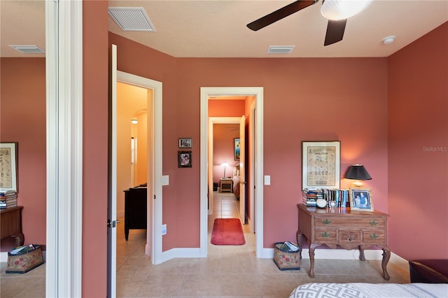 tiled bedroom featuring ceiling fan