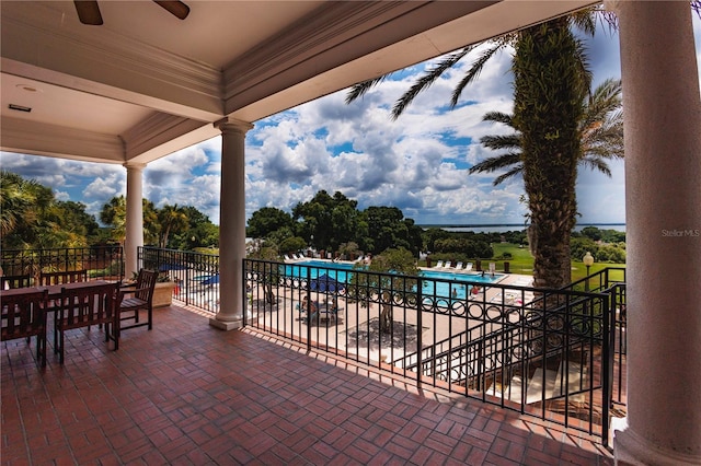 view of patio featuring ceiling fan and a balcony