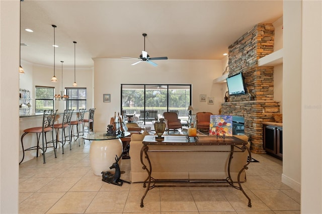 living room with ceiling fan, light tile patterned floors, and crown molding