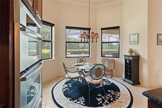 dining area featuring light tile patterned floors, ornamental molding, and an inviting chandelier