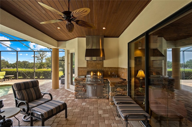 view of patio / terrace with area for grilling, ceiling fan, a lanai, and sink