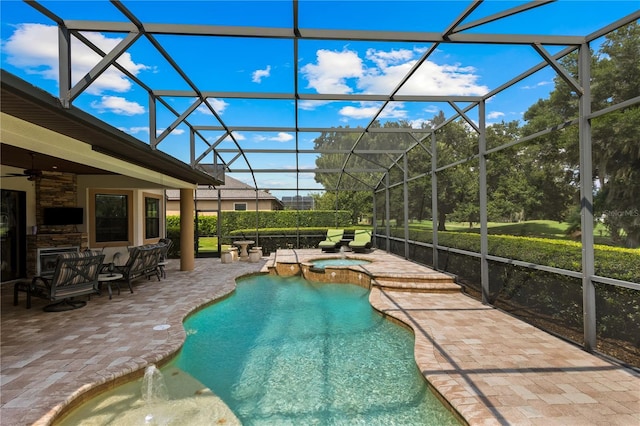 view of pool with an in ground hot tub, a patio, ceiling fan, and a lanai