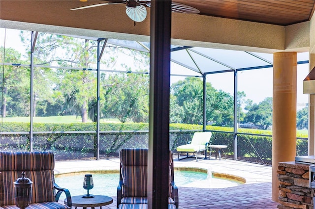 interior space featuring ceiling fan and glass enclosure