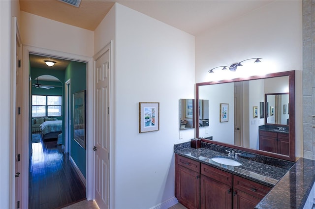 bathroom with vanity, ceiling fan, and wood-type flooring