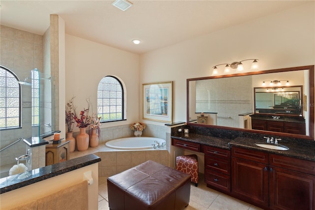 bathroom featuring tile patterned flooring, vanity, and separate shower and tub