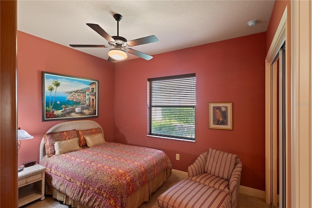 tiled bedroom with ceiling fan