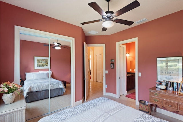 bedroom featuring ceiling fan, a closet, and light tile patterned floors