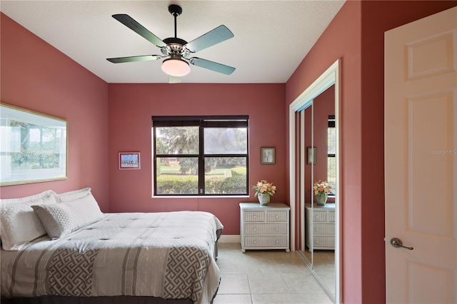 bedroom with ceiling fan and light tile patterned floors