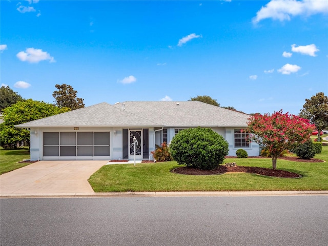 ranch-style house featuring a garage and a front lawn