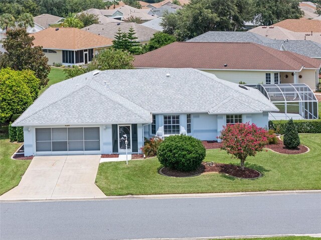 view of front of house with a garage and a front lawn