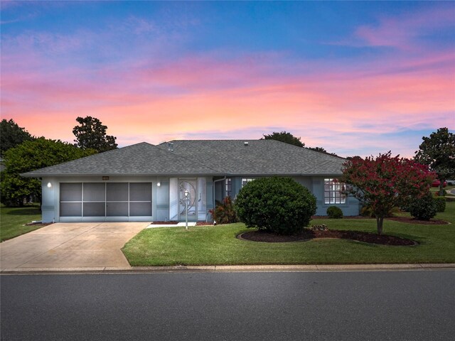 ranch-style home with a lawn and a garage