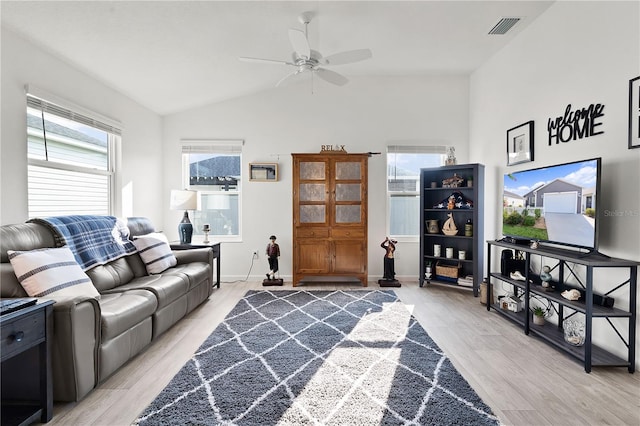 living room with ceiling fan, lofted ceiling, and light hardwood / wood-style floors