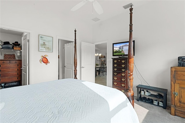 bedroom with ceiling fan with notable chandelier and carpet flooring