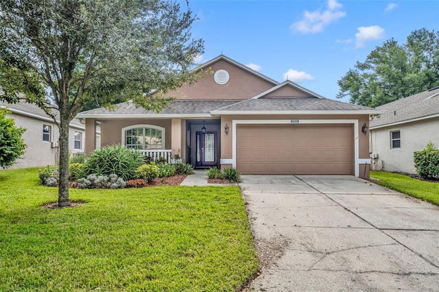 view of front of house with a garage and a front yard