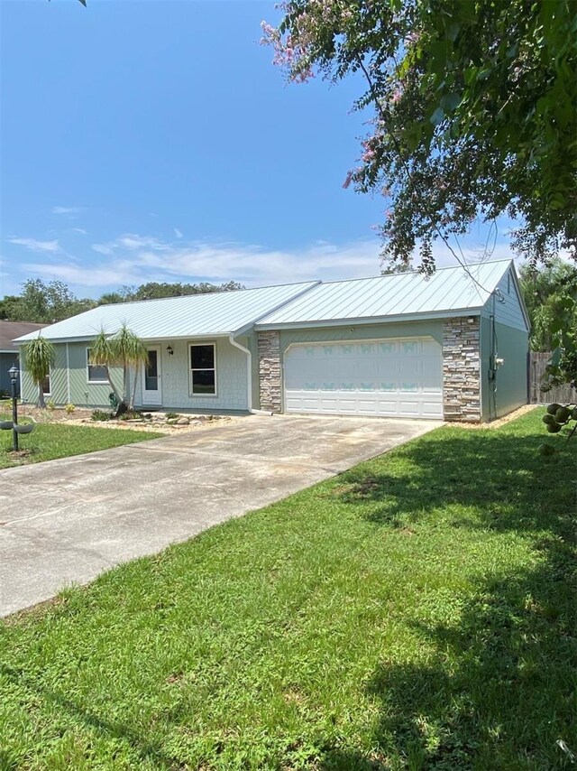 ranch-style home with a garage and a front lawn