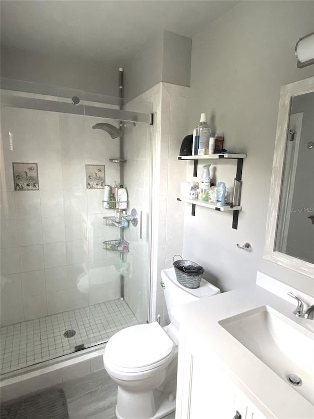 bathroom with vanity, toilet, and an enclosed shower