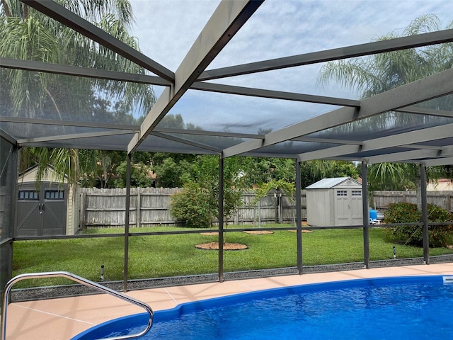 view of pool with a patio, a storage shed, and a yard