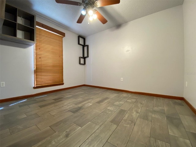 unfurnished room featuring a textured ceiling, hardwood / wood-style flooring, and ceiling fan