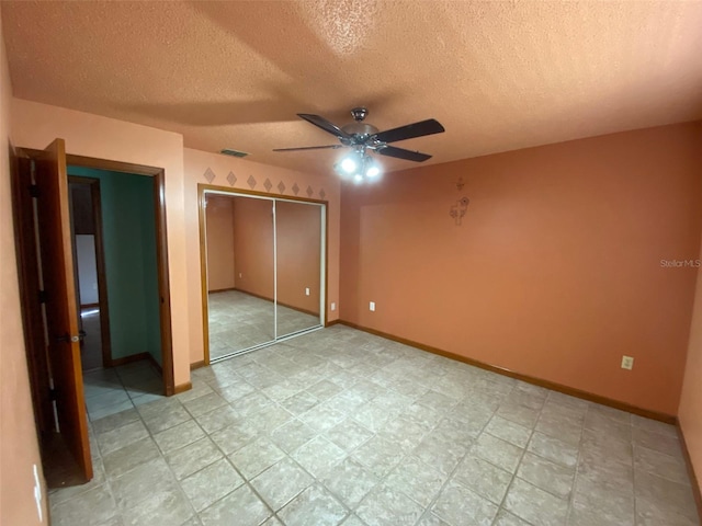 unfurnished bedroom featuring a closet, a textured ceiling, and ceiling fan