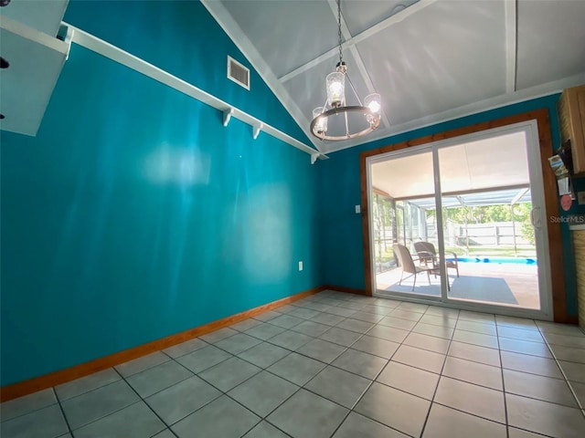 unfurnished room featuring a chandelier, high vaulted ceiling, and tile patterned floors