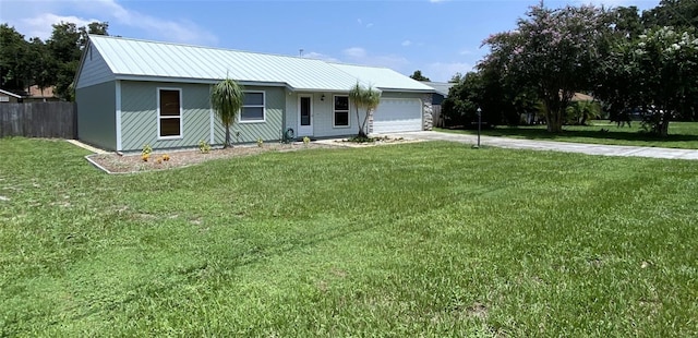 single story home featuring a garage and a front lawn