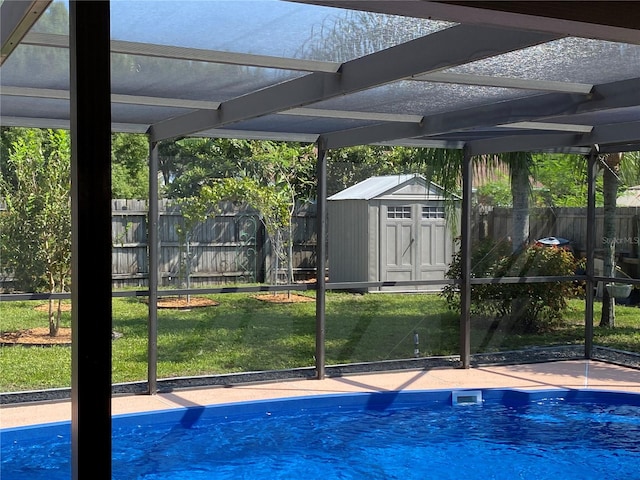 view of swimming pool with a yard and a storage unit