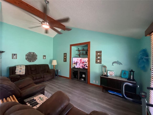 living room featuring ceiling fan, lofted ceiling with beams, wood-type flooring, and a textured ceiling