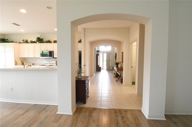 hallway with light hardwood / wood-style flooring