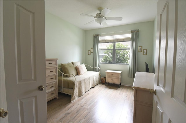 bedroom with ceiling fan and light hardwood / wood-style flooring