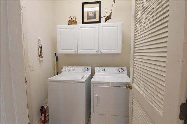 laundry area with cabinets and washer and clothes dryer