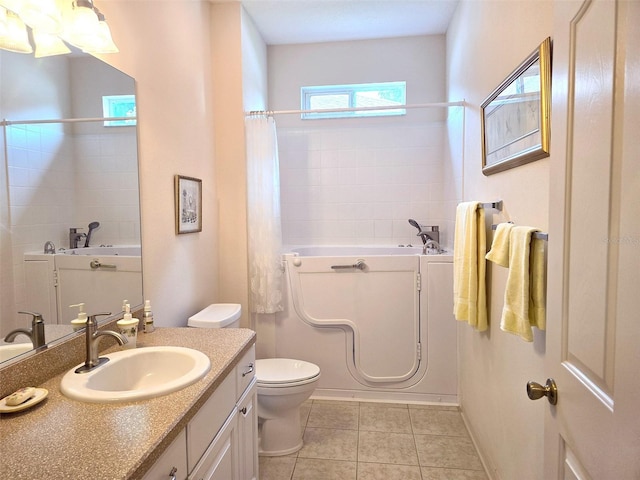 bathroom featuring vanity, tile patterned flooring, and toilet