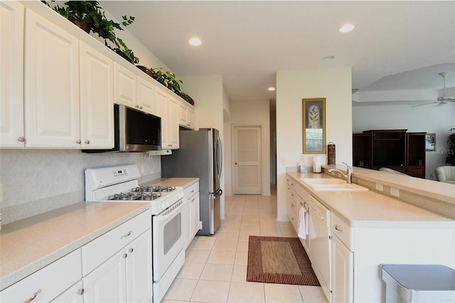 kitchen with ceiling fan, light tile patterned floors, backsplash, white appliances, and sink