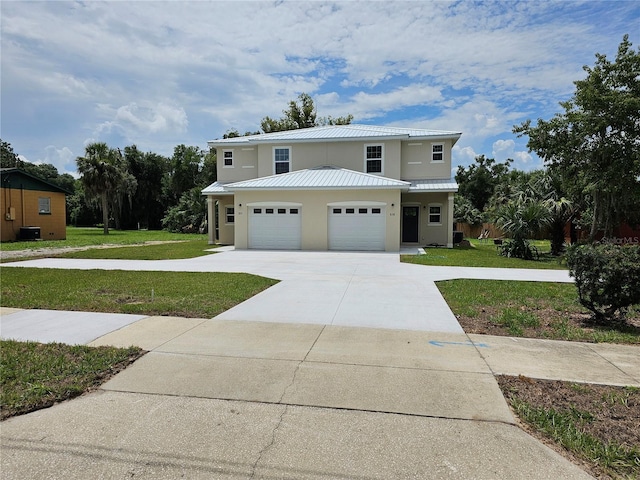 view of front of property featuring a garage and a front yard