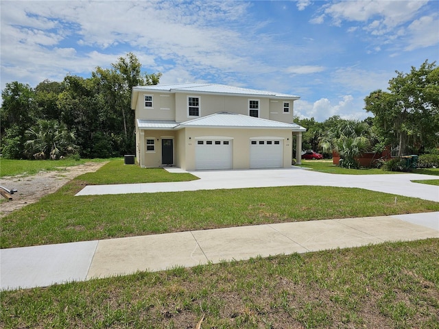 view of front facade with a garage, central AC unit, and a front lawn