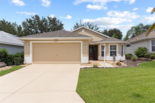 ranch-style house featuring a front yard and a garage