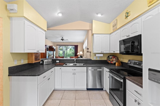 kitchen featuring a textured ceiling, vaulted ceiling, sink, and stainless steel appliances