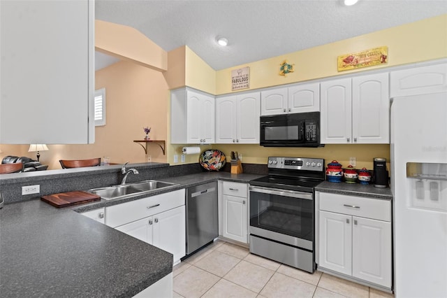 kitchen with white cabinets, kitchen peninsula, appliances with stainless steel finishes, and sink