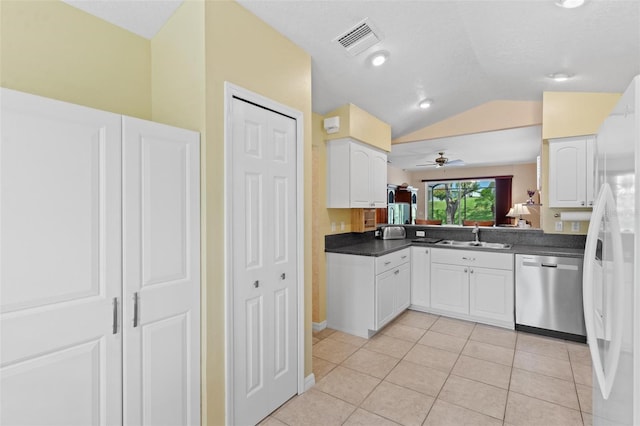 kitchen featuring ceiling fan, white cabinets, dishwasher, and vaulted ceiling