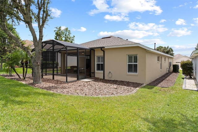 back of property featuring a lawn and a lanai