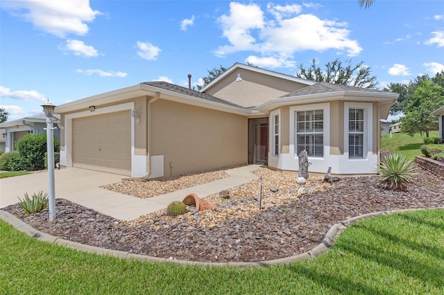 single story home featuring a garage and a front lawn