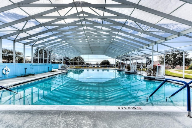 view of swimming pool with glass enclosure