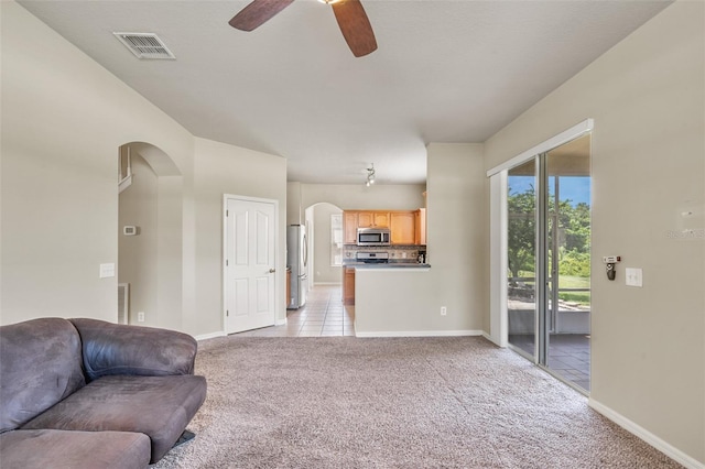 living room featuring light carpet and ceiling fan