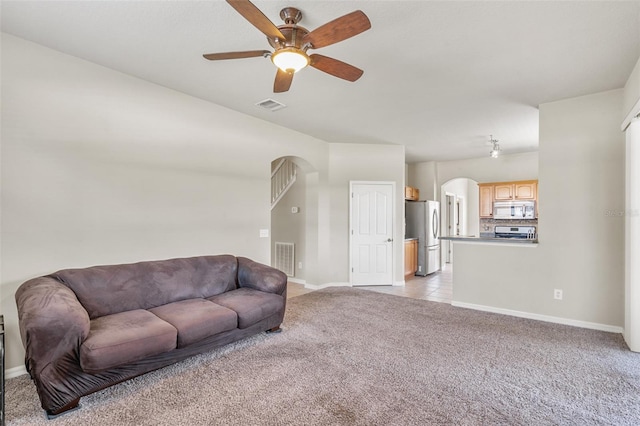 living room featuring ceiling fan and light carpet