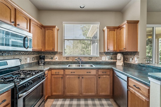 kitchen featuring appliances with stainless steel finishes, decorative backsplash, light tile patterned floors, and sink