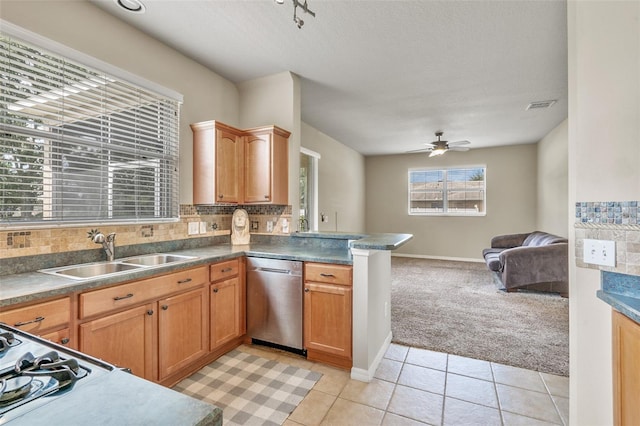 kitchen with backsplash, sink, ceiling fan, dishwasher, and light tile patterned floors